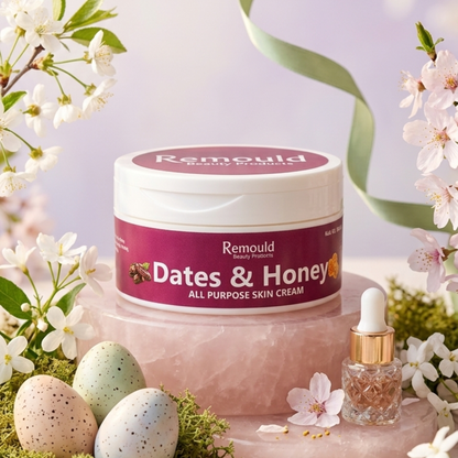 Remould Dates and Honey All Purpose Skin Cream jar with burgundy label on rose quartz surrounded by white spring blossoms and natural ingredients
