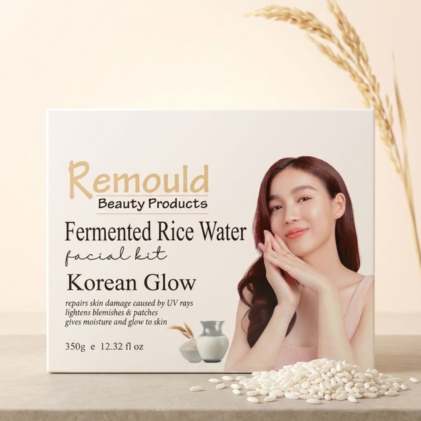 Remould Fermented Rice Water Facial Kit Korean Glow box displayed on white pedestal with scattered rice grains and cherry blossom branches